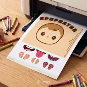 A printable Bible activity sheet about Jesus healing a deaf man coming out of a home printer, surrounded by colorful crayons on a wooden desk.
