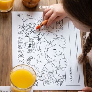 nurtuz home 2 Child coloring a free Thanksgiving printable placemat featuring a little turkey. Kids Thanksgiving table activity and coloring page from Nurtuz.